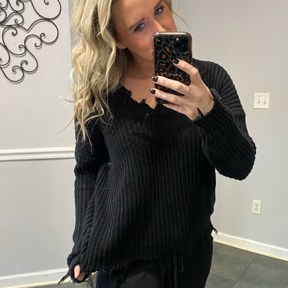 Shorter length, distressed, black sweater
